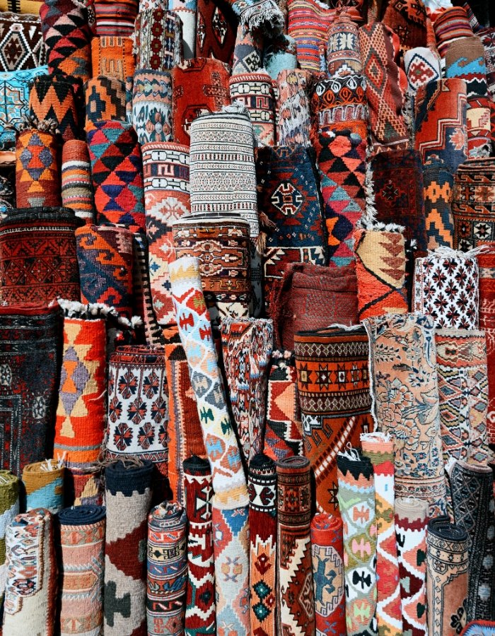 a group of colorful rugs