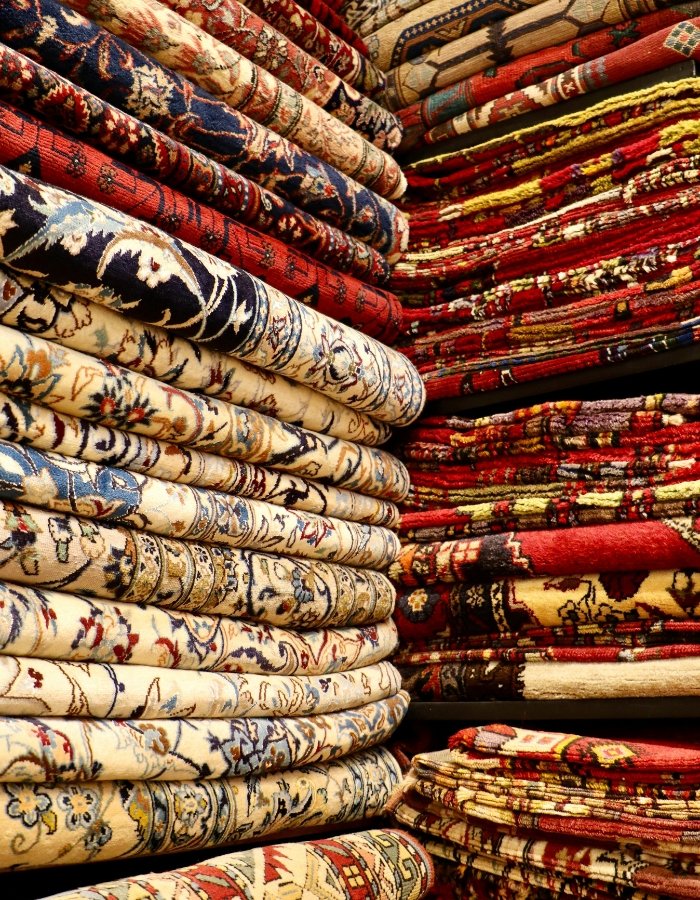a stack of colorful rugs